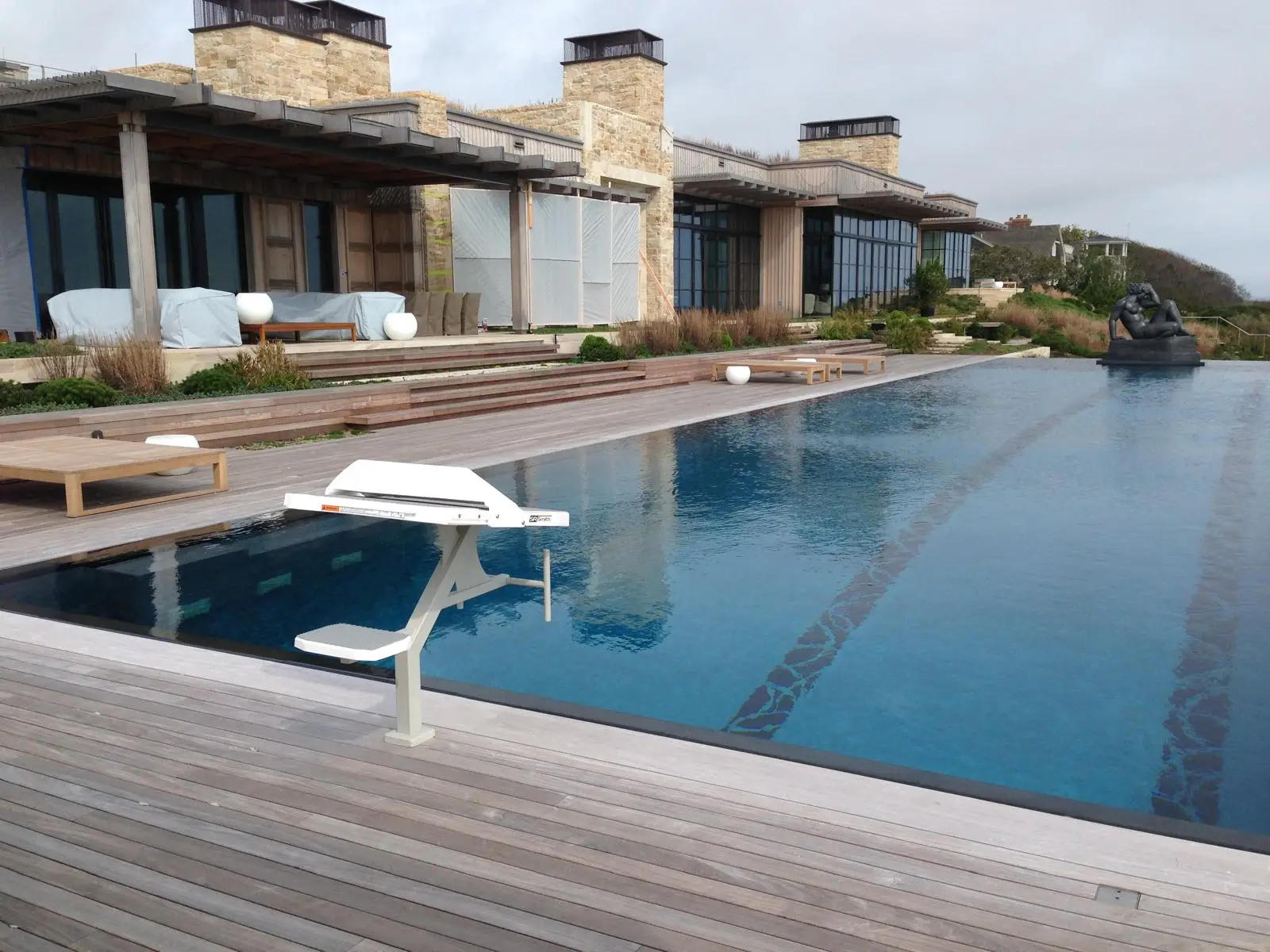A starting block at the end of a lap pool with lane lines. Nobody in frame.